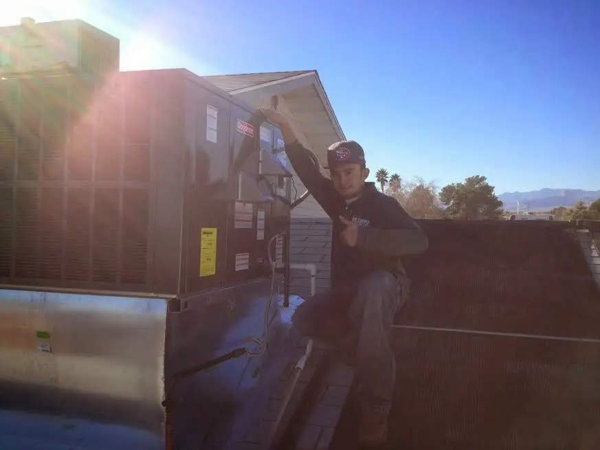 HVAC technician performing HVAC Inspection on a rooftop unit in Garden Grove